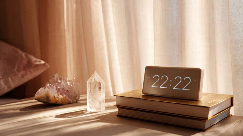 Digital clock showing 2:22 in a modern home, representing the balance and harmony of angel numbers.