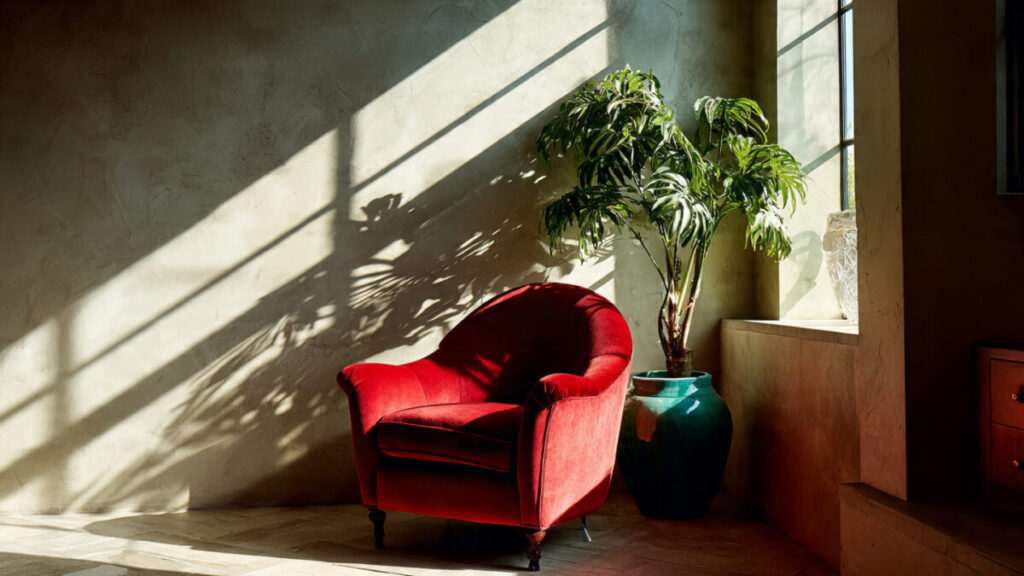 Modern living room with red armchair and green plants for Feng Shui 2026