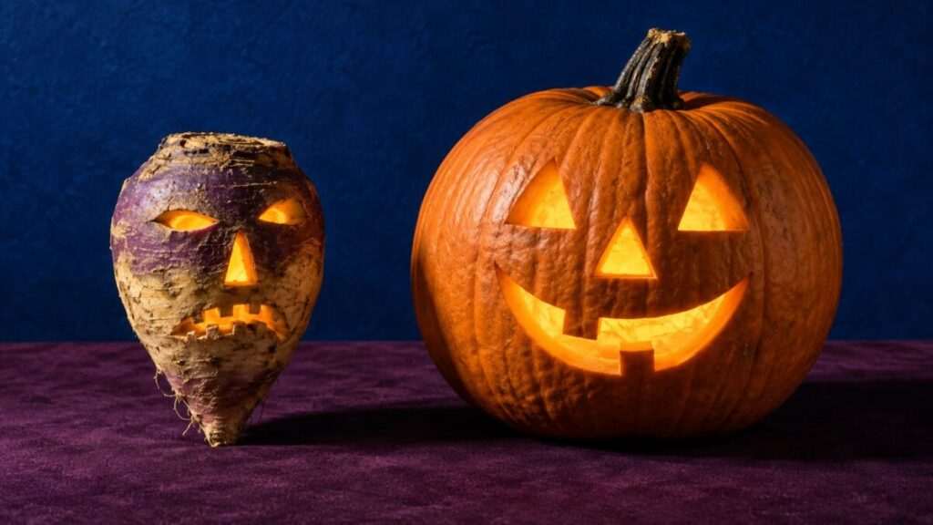 Glowing turnip and pumpkin lanterns side by side on a purple surface against a blue background.